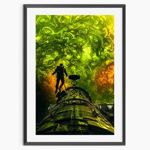 May include: A framed wall art print depicting a silhouette of an astronaut floating above a metallic spacecraft structure. The background features a swirling, vibrant nebula of bright lime green and deep orange hues, creating a high-contrast cosmic scene.