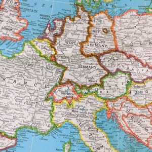 May include: A detailed map of Europe, featuring countries like France, Germany, and Italy, with city names and borders. The map is printed on a light blue background, with a focus on Western and Central Europe.