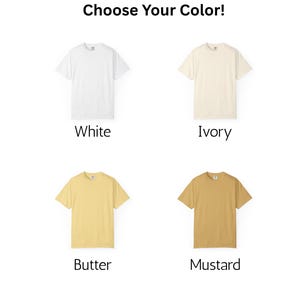 May include: Image featuring four short-sleeved t-shirts in different colors: white, ivory, butter, and mustard. The text "Choose Your Color!" is at the top. Each shirt is displayed on a white background, showcasing the available color options.