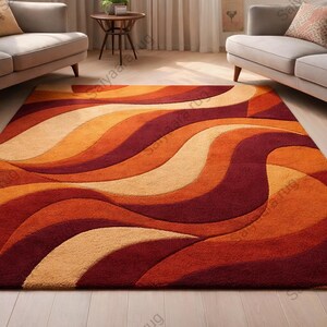 May include: A large, rectangular area rug with a flowing, abstract design in shades of orange, red, and beige. The rug's pattern resembles waves, creating a warm and inviting aesthetic for a living space.