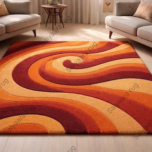 May include: A large, rectangular area rug with a swirling, abstract design in shades of orange, red, and beige. The rug's pattern creates a sense of movement and warmth, suitable for a living room or similar space.