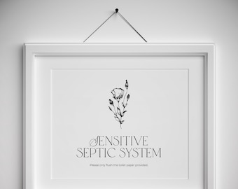May include: A white framed sign with a black and white illustration of a flower. The sign reads "Sensitive Septic System. Please only flush the toilet paper provided."  The bottom of the sign reads "Paper Pixels".