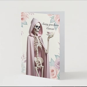 May include: A greeting card featuring a skeleton figure in a pink hooded cloak, holding a teacup. The card has the text "Sorry you have Cancer" and is decorated with floral elements in soft pink and green.