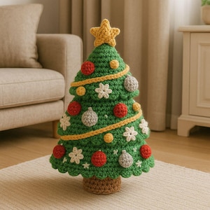 May include: A handmade crochet Christmas tree. The tree is green with yellow trim and decorated with red, gray, and yellow ornaments, and white snowflake accents. A yellow star tops the tree, and the base is brown.