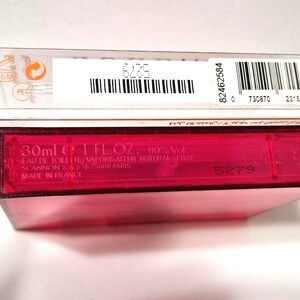 May include: A close-up of a pink rectangular perfume bottle with a clear plastic box on top. The bottle has the text "30ml 1 FL.OZ. 80%Vol." and "MADE IN FRANCE". The clear box has a barcode and the text "36M".
