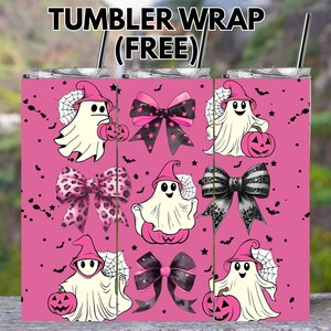 May include: Pink tumbler wrap featuring Halloween-themed designs. The wrap includes cartoon ghosts, bows, and pumpkins. The text "TUMBLER WRAP (FREE)" is at the top. The design is repeated across the tumbler.