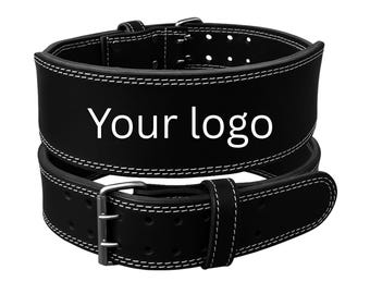 May include: Black weightlifting belt with white stitching and a silver buckle. The belt has the text "Your logo" in white. The belt is designed to provide support during weightlifting exercises.