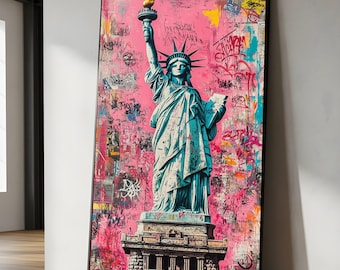 May include: A framed canvas print of the Statue of Liberty against a pink graffiti-style background. The statue is teal, with a gold torch. The background features colorful spray paint and scribbled text.