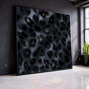 May include: Large framed artwork featuring a dark gray and black leopard print pattern. The abstract design has a textured appearance, with varying shades of gray and black creating depth. The artwork is displayed in a modern, minimalist interior setting.
