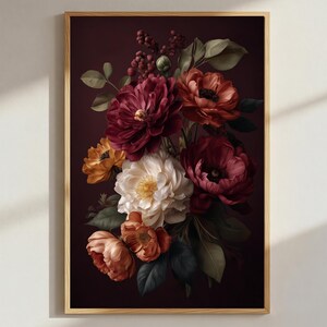 May include: A framed floral print featuring a bouquet of flowers in shades of burgundy, orange, and cream against a dark background. The flowers include peonies and other blooms, with green leaves and berries. The frame is a light wood color.