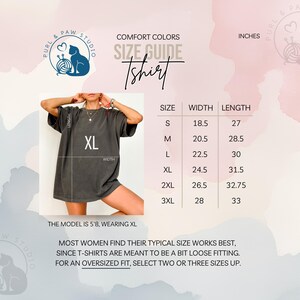 May include: A size guide for a Comfort Colors t-shirt, with measurements in inches. The model is wearing an XL. The guide includes sizes S, M, L, XL, 2XL, and 3XL, with corresponding width and length measurements. The text advises women to select two or three sizes up for an oversized fit.