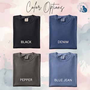 May include: Image showcasing four t-shirt color options: black, denim, pepper, and blue jean. Each shirt is displayed with its respective color name underneath. The text "Color Options" is written in cursive at the top of the image.
