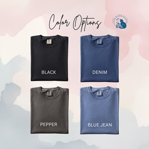 May include: Four folded crew neck t-shirts arranged in a grid. The shirts are labeled Black, Denim, Pepper, and Blue Jean. The text Color Options is centered at the top, and a Purl & Paw Studio logo is in the upper right corner.