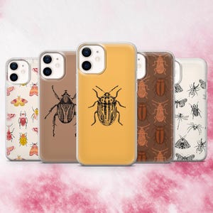 May include: A collection of five phone cases with insect illustrations. The cases feature various designs, including beetles, moths, and other bugs, in shades of brown, yellow, and cream. The cases are displayed against a pink and white background.