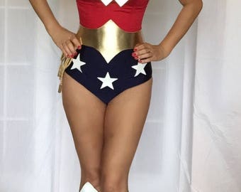 May include: A red, gold, and blue Wonder Woman costume with a white star pattern. The costume includes a strapless top, a skirt, and boots.