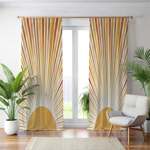 May include: A pair of window curtains with a sunburst design. The curtains feature vertical stripes in shades of yellow, orange, and brown radiating from a golden yellow semi-circle at the bottom. The curtains are hanging in front of a window, with a chair and plants in the room.