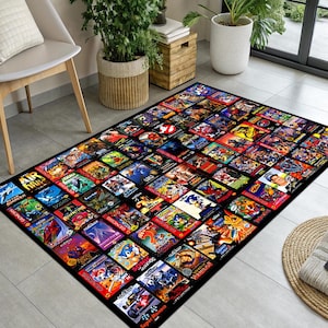 May include: A rectangular black rug featuring a collage of colorful video game box art. The rug showcases various game titles with vibrant illustrations and logos, creating a retro gaming theme. The rug is placed on a tiled floor.