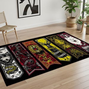 May include: A rectangular black area rug featuring stylized banners with various animal crests. The banners include a wolf, dragon, lion, stag, and wolf, each with intricate details and text. The rug is placed on a wooden floor.
