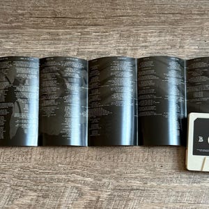 May include: A cassette tape labeled "Avenged Sevenfold Hail to the King" with a black and white design. The album insert is open, displaying lyrics and artwork. A clear plastic cassette case is partially visible.