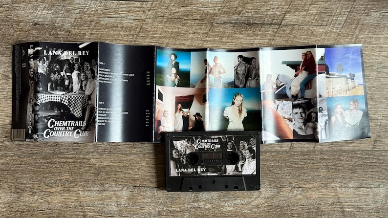 May include: A black cassette tape and album art from Lana Del Rey's "Chemtrails Over the Country Club" album. The album art features a collage of photos and the cassette tape has the album title and artist's name.