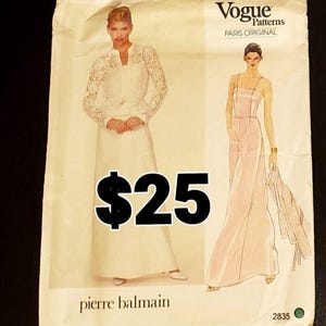 May include: A Vogue Patterns Paris Original sewing pattern envelope, number 2835, by Pierre Balmain. The front displays illustrations of two outfits: a white long-sleeved lace top with a matching skirt, and a pale pink floor-length sleeveless dress.