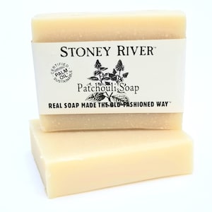 May include: Two bars of Stoney River Patchouli Soap, made with certified sustainable palm oil. The soap is packaged in a white wrapper with black text and a drawing of a patchouli plant.