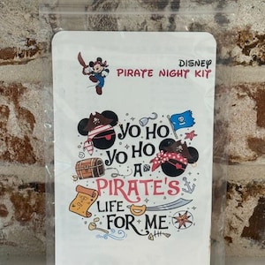May include: A white Disney Pirate Night Kit package with pirate-themed graphics. The design includes Mickey Mouse as a pirate, treasure chest, scroll, and the text "Yo Ho, A Pirate's Life For Me."