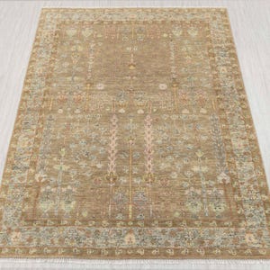 May include: A rectangular beige rug with a detailed floral design. The rug has a central field with vertical floral patterns and a decorative border. The color scheme includes beige, pink, blue, and yellow, creating a warm and inviting look. The rug is suitable for a living room.