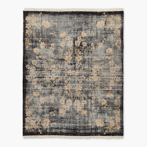 Puede incluir: Alfombra rectangular de aspecto envejecido, con fondo gris oscuro y un estampado floral en beige y crema. La alfombra tiene un borde con flecos y un dise&ntilde;o central de medall&oacute;n floral.
