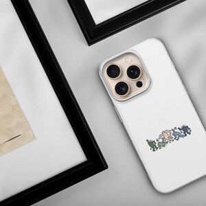 May include: White phone case with a colorful graphic of stylized figures in a row. The case has a clear border and a camera cutout. The image is on a light gray surface, with a framed artwork in the background.