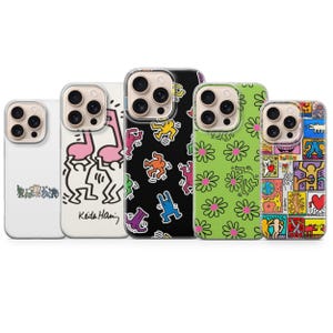 May include: A collection of five phone cases with colorful designs. The cases feature various patterns, including Keith Haring-inspired figures, daisies, and abstract shapes. The cases are designed to fit a smartphone.