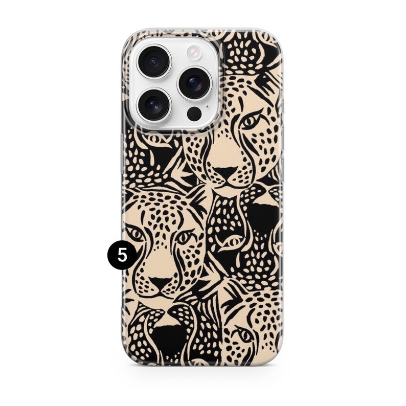 May include: A phone case featuring a repeating pattern of cheetah faces in black and tan. The case has a clear border and a camera cutout. The number 5 is printed in black on the bottom left corner of the case.