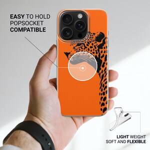 May include: Orange phone case with a black leopard design. The case is compatible with Popsockets and is lightweight and flexible. Text on the case reads "EASY TO HOLD POPSOCKET COMPATIBLE" and "LIGHT WEIGHT SOFT AND FLEXIBLE".