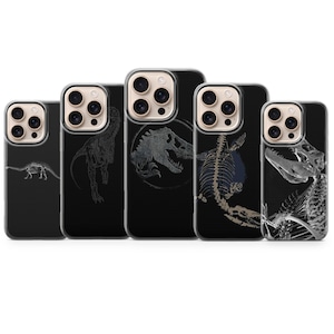 May include: Five black phone cases with dinosaur designs. The cases feature various dinosaur illustrations, including skeletons and a T-Rex, in white and gray. The cases are for a smartphone.