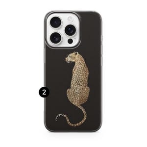 May include: A black iPhone case featuring a detailed illustration of a leopard with a tan and brown spotted coat. The leopard is seated, with its tail curled. The case has a clear border and a camera cutout.