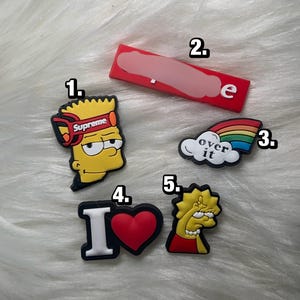 May include: A set of three ceramic mugs with a speckled, matte finish. The mugs are in shades of cream, light gray, and dark gray. Each mug has a simple, minimalist design and a rounded handle.