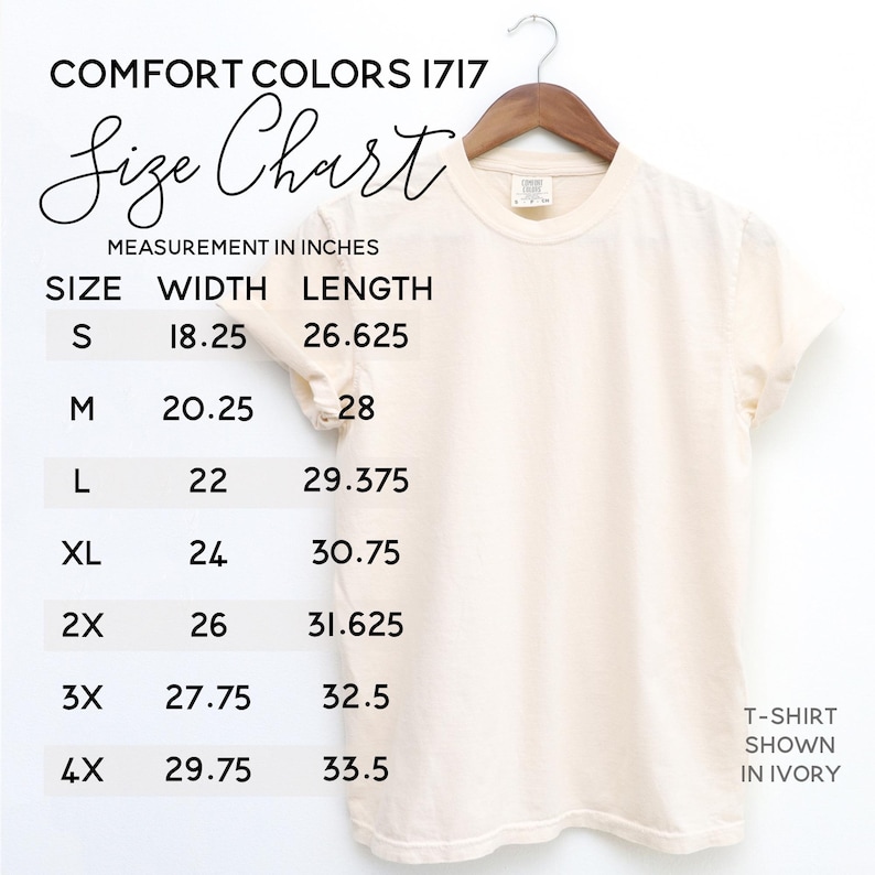 May include: Ivory-colored Comfort Colors 1717 t-shirt displayed on a hanger. The image includes a size chart with measurements in inches for sizes S through 4X. The text on the chart includes width and length measurements.