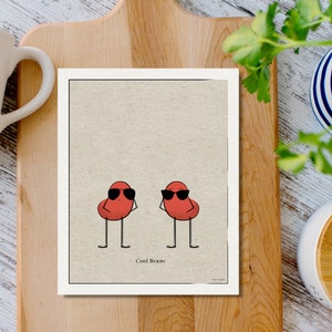 May include: A printable art print featuring two red beans wearing sunglasses. The beans have stick legs and arms. The text "Cool Beans" is printed below the beans.