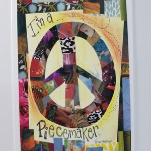 May include: A colorful peace sign made of paper scraps with the words "I'm a... Peacemaker" written around it. The background is a collage of different patterns and textures.