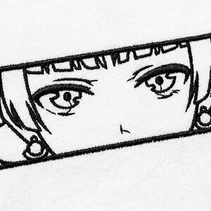 May include: A rectangular black embroidery design on a white fabric background featuring the stylized eyes and hair of an anime character. The black thread outlines the detailed iris, eyelashes, and bangs within a bold, solid black rectangular border.