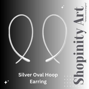 May include: A pair of silver oval hoop earrings. The earrings have a simple, elegant design with a smooth, polished finish. The text "Shopinity Art" and "Where trend begins" is displayed on the right side of the image. The words "Silver Oval Hoop Earring" are at the bottom.