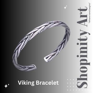 May include: A silver Viking bracelet with a braided design. The open cuff bracelet has a textured pattern and is displayed against a gradient grey background. The text "Viking Bracelet" is at the bottom of the image.