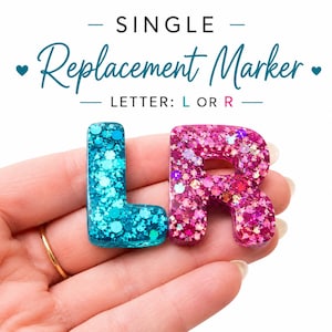 Puede incluir: Dos marcadores de letras de resina, uno turquesa y otro rosa, ambos rellenos de purpurina gruesa. El texto superior dice: SINGLE Replacement Marker LETTER: L OR R. Las letras L y R se muestran como piezas individuales con un acabado brillante.