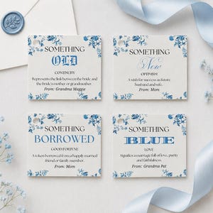 May include: Four rectangular white paper tags with blue floral borders. Each tag features text: Something Old, Something New, Something Borrowed, and Something Blue. The tags include definitions and sender names like Grandma Maggie, Mom, and Grandma Pat.