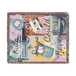 May include: Woven throw blanket with a retro 90s theme. The design features a repeating pattern of vintage electronics like a handheld game console, a cassette tape, and a digital pet toy. The text "Kids These Days Could Never" is written across the blanket.