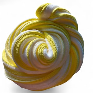 May include: A swirl of yellow and white slime, a popular sensory toy. The colors are layered in a spiral pattern, creating a visually appealing texture. The background is plain white.