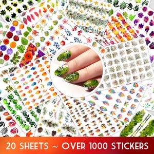 May include: A collection of nail art stickers featuring various floral, leaf, and botanical designs. The stickers include images of flowers, leaves, and other natural elements in a variety of colors. The image also shows a hand with green leaf-patterned nail art. The text reads "20 SHEETS ~ OVER 1000 STICKERS."