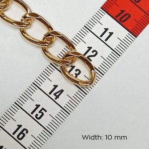 May include: Gold chain link with a width of 10 mm, measured with a tape measure.