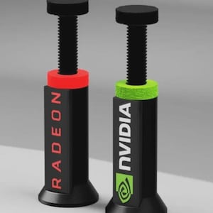 Może przedstawiać: Dwie czarne śruby do obudowy komputera, jedna z napisem "RADEON" w kolorze czerwonym, a druga z napisem "NVIDIA" i zielonym logo. Każda ma czarną górę i gwintowany czarny trzpień. Czerwone i zielone akcenty.