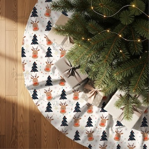 May include: A white Christmas tree skirt with a repeating pattern of reindeer, Christmas trees, and stars. The skirt is under a decorated Christmas tree with wrapped gifts.